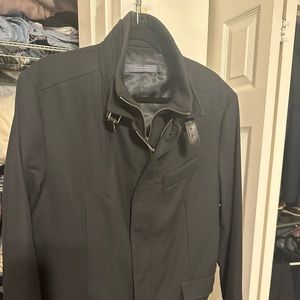 Man’s waist length wool jacket with Nehru collar. Zippered inner lining.